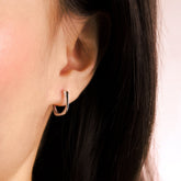 Fine jewellery, silver jewellery, hypoallergenic, tarnish-free, close-up right view of a  squarish silver hoop earrings worn on a person's ear